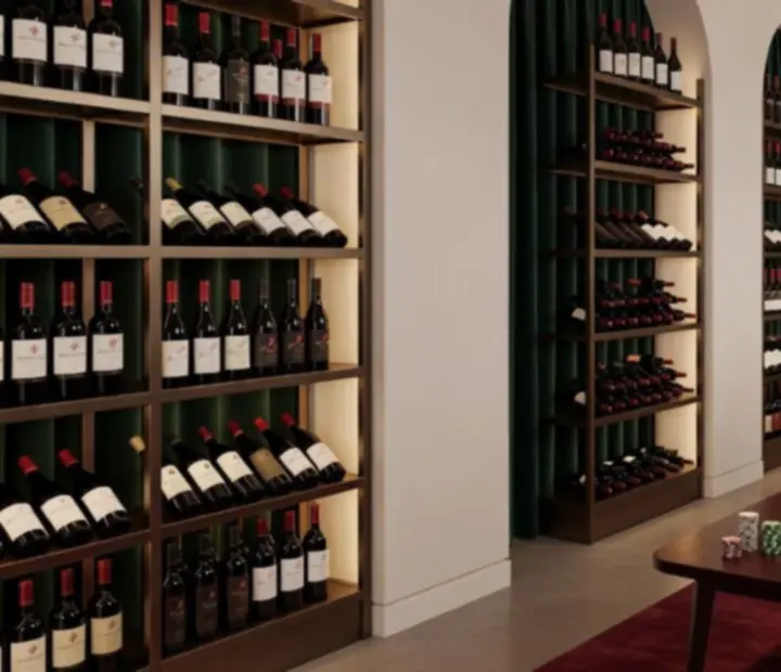 Elegant wine cellar interior with premium bottles displayed under warm lighting.