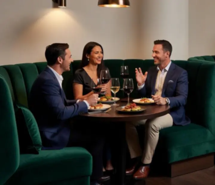 Wine lounge with deep emerald booths and subtle casino-themed decor.